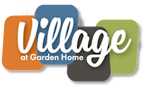 The image is a logo for "The Village at Garden Home".