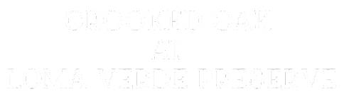 A green sign with white text that reads "Crooked Oak at Loma Verde Preserve".