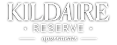 A black and white image of a sign for KILDAIRE RESERVE apartments.