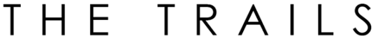 The image displays the words "THE TRAILS" in large, bold letters.