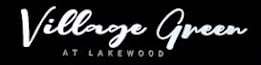 A black sign with the words "Village Green at Lakewood" written in white cursive.
