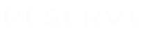 A logo with the text "RESERVE AT WHITE ROCK" with a stylized mountain and water design.