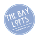A blue circular logo with the text "The Bay Lofts" and "Sturgeon Bay WI" on it.