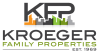 the logo for kroeger family properties with a city skyline