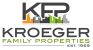 the logo for kroeger family properties with a city skyline