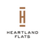 A logo with a brown heart shaped figure above the words "Heartland Flats".