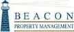 A lighthouse is pictured on a sign for Beacon Property Management.