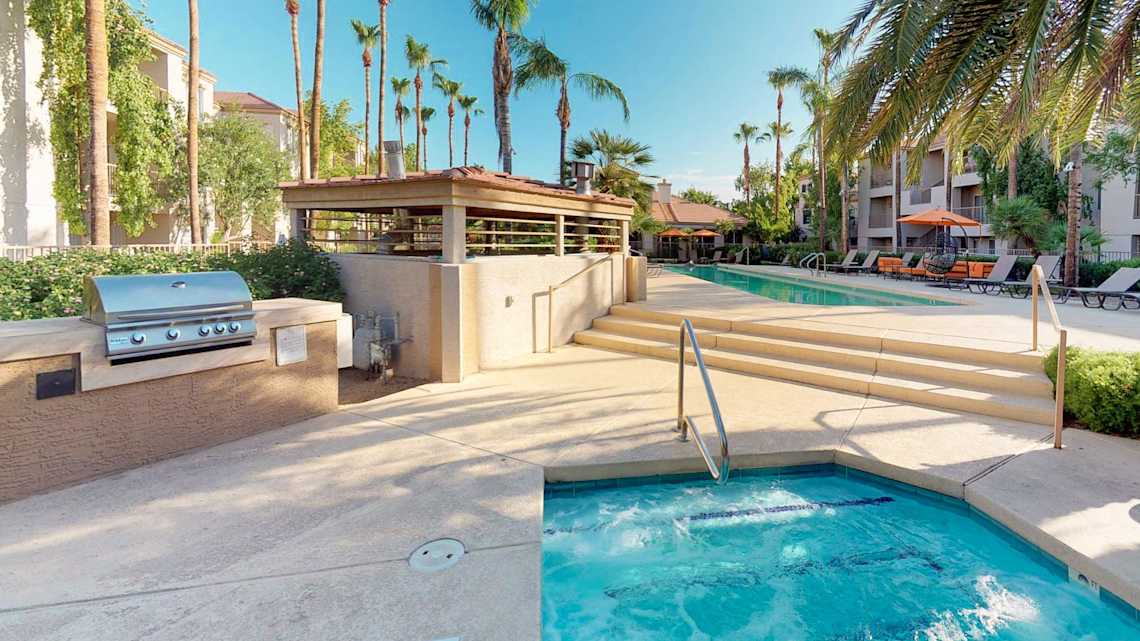 Pool and poolside area at Cortina Apartments.