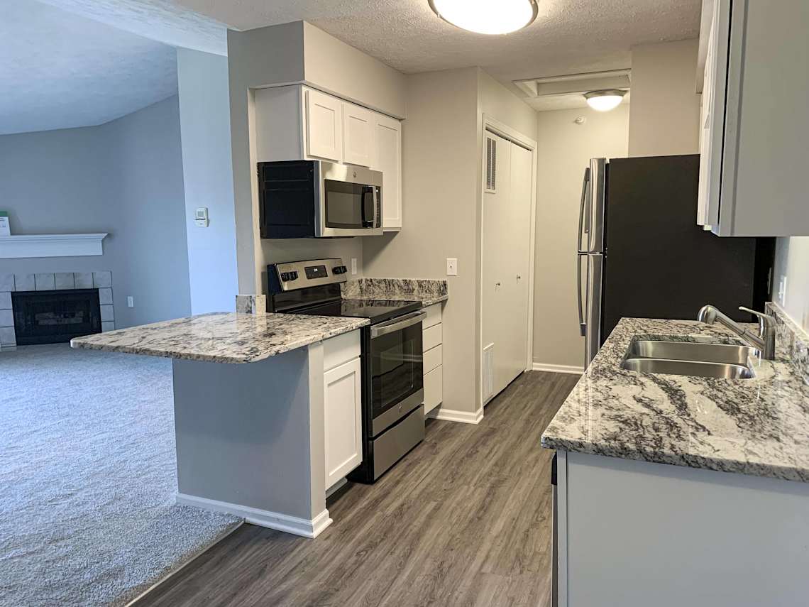 Renovated style A kitchen with granite countertops and stainless steel appliances