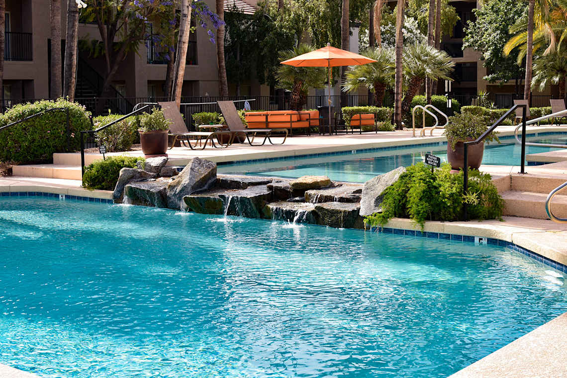 Pool and poolside area at Cortina Apartments.