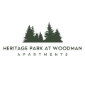 a logo for heritage park at woodman apartments
