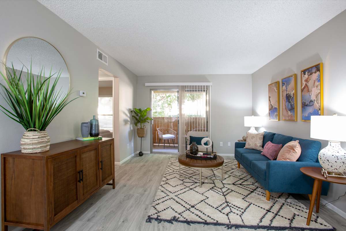 Furnished apartment living area shown — representative home at Ascent on Peoria.