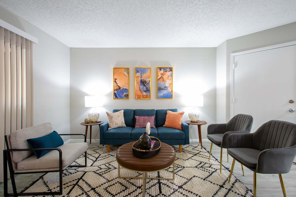 Furnished apartment living area shown — representative home at Ascent on Peoria.
