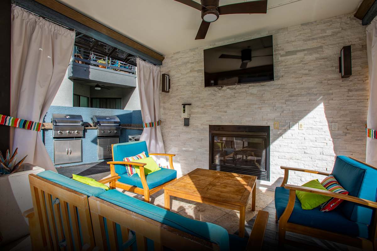 Covered patio seating and fireplace at Ascent North Scottsdale.