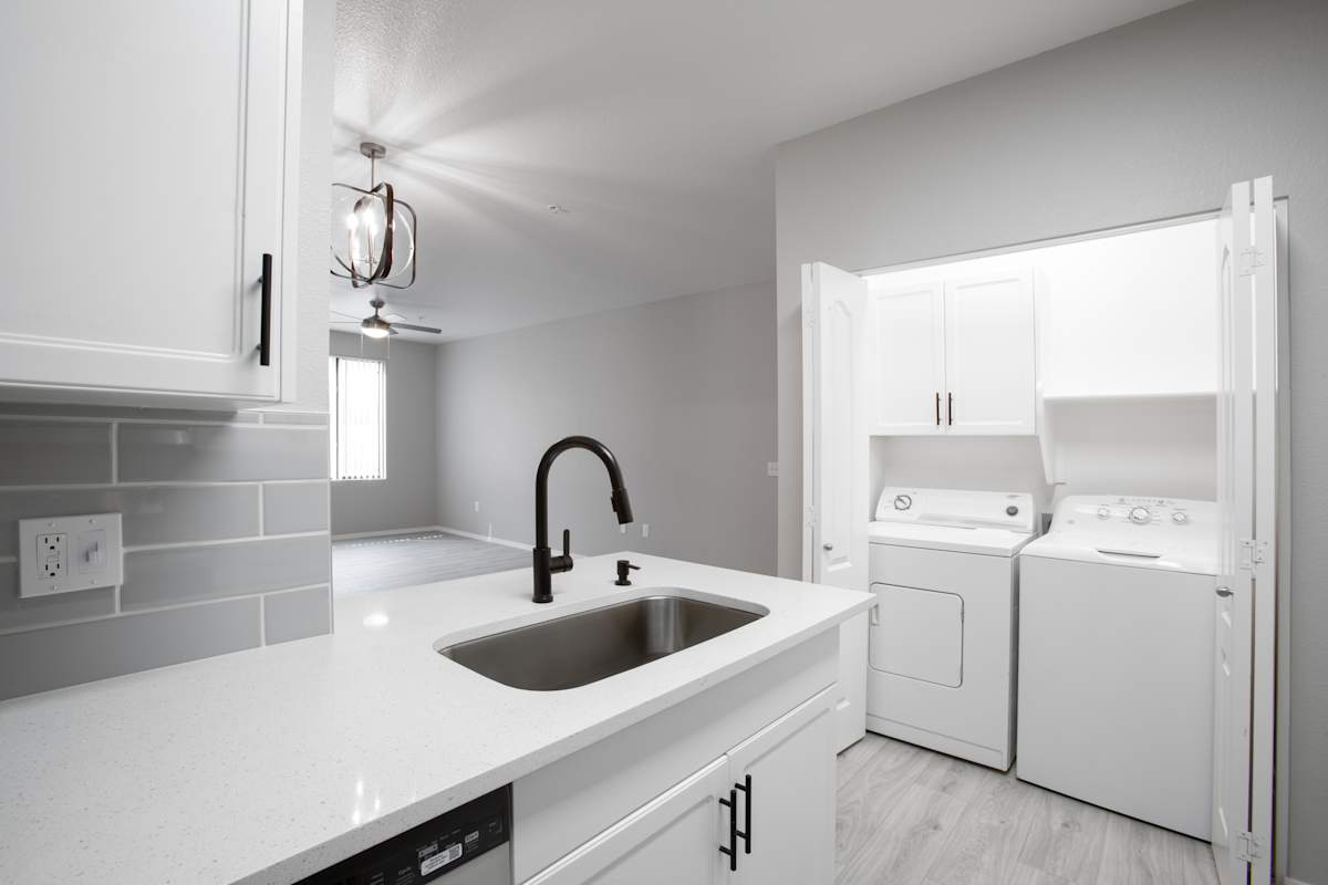 Kitchen sink beside the laundry area at Ascent North Scottsdale.