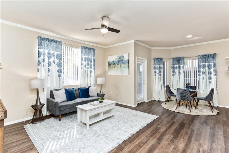 Furnished apartment living area shown — representative home at San Riva At The Foothills.