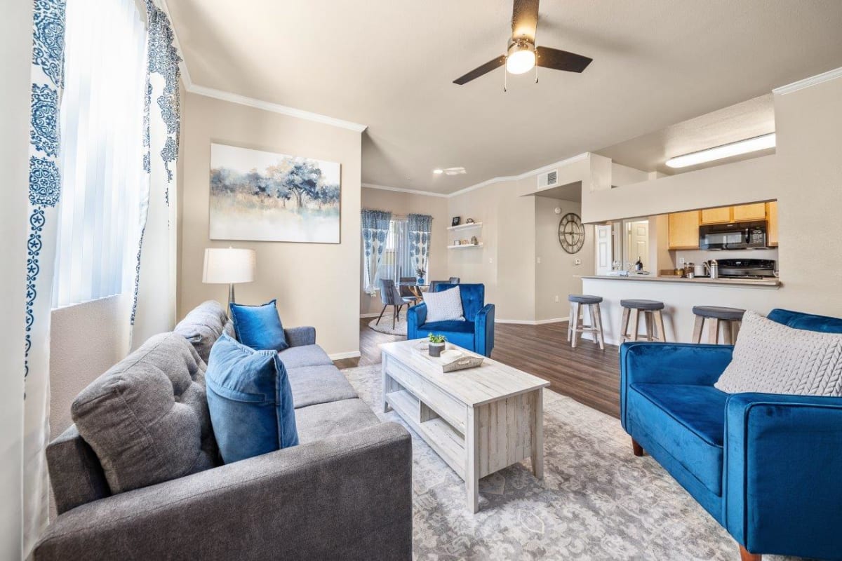 Furnished apartment living area shown — representative home at San Riva At The Foothills.