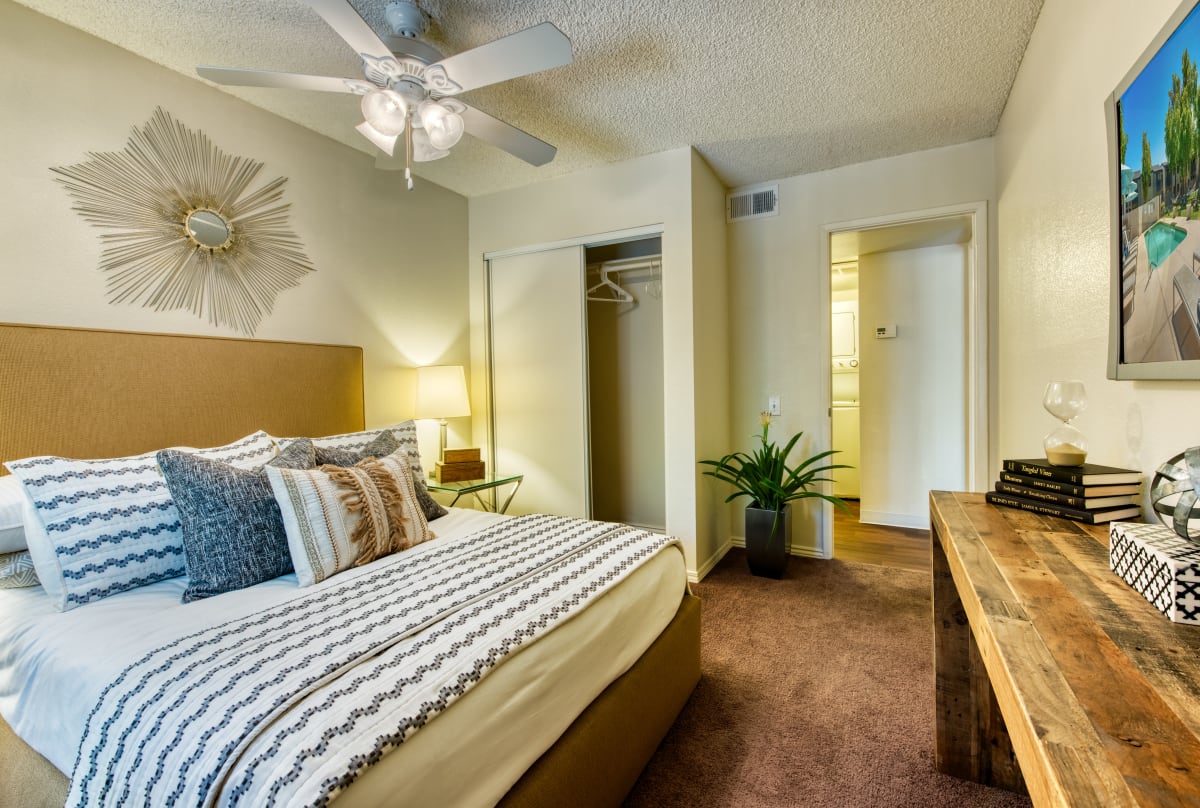 Furnished bedroom with ceiling fan — view 1 at Connect on Northern Apartments.