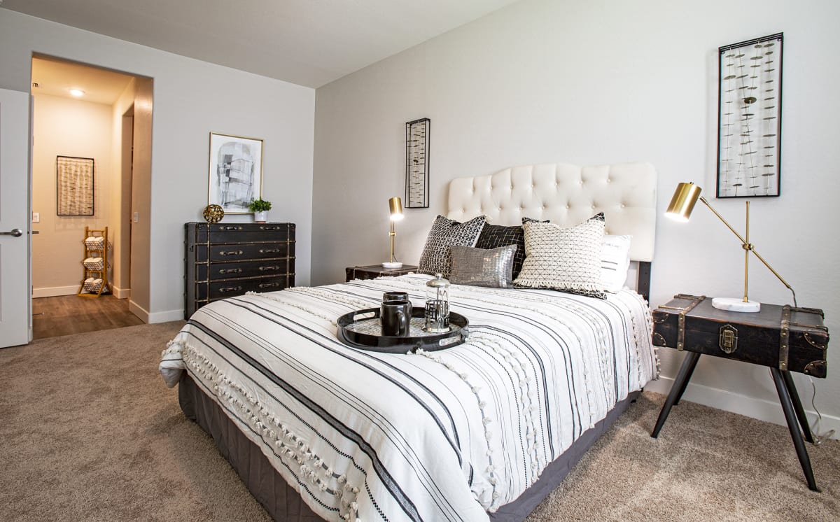 Furnished bedroom shown — representative home at Senderos at South Mountain.