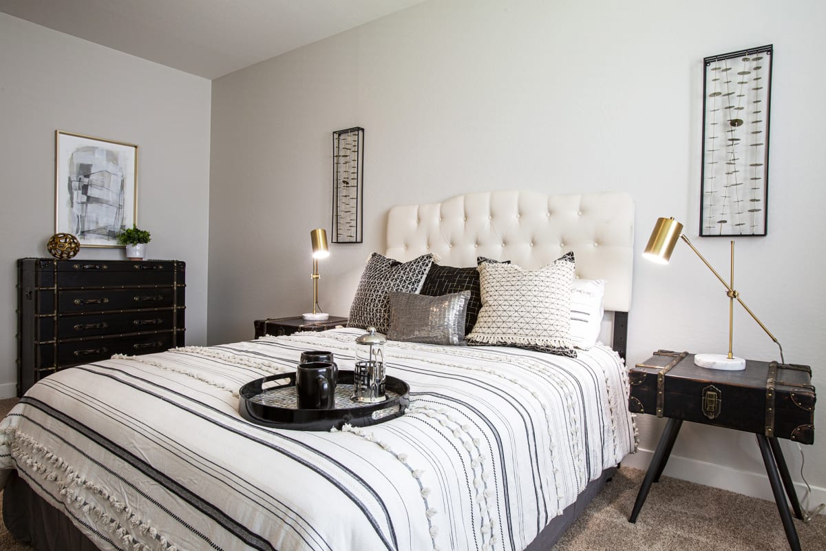 Furnished bedroom shown — representative home at Senderos at South Mountain.