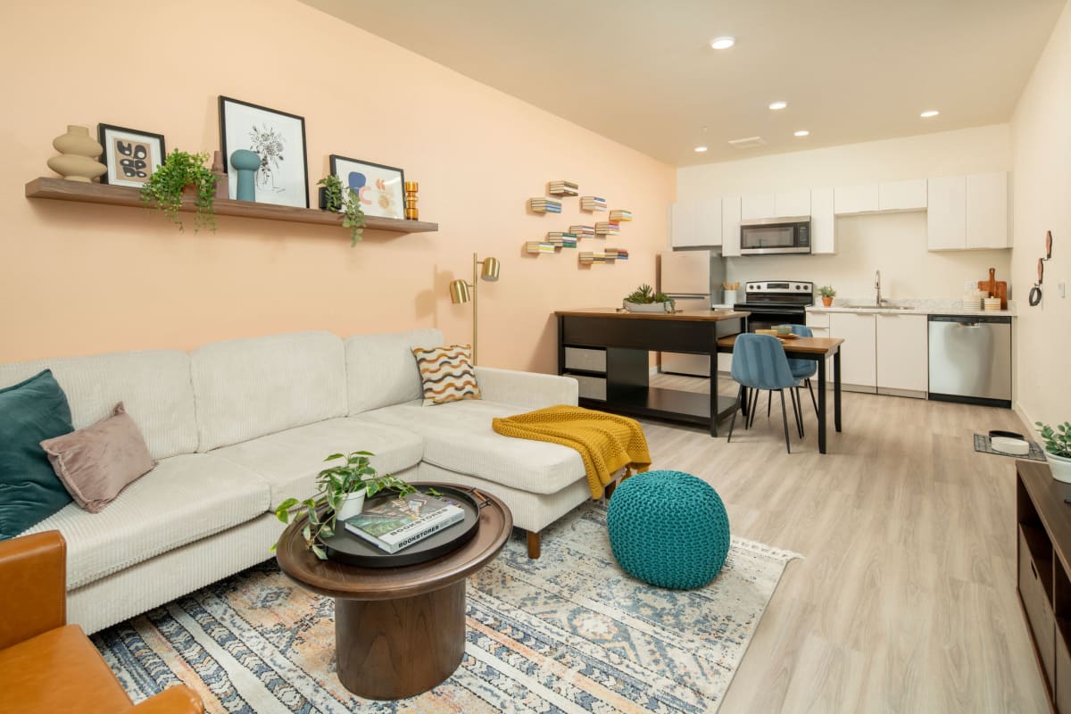 Furnished apartment living area shown — representative home at Streamliner 67th.