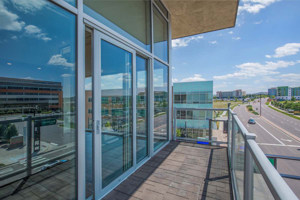 Lofts at Lincoln Station balcony with glass doors and city view - Lone Tree, CO