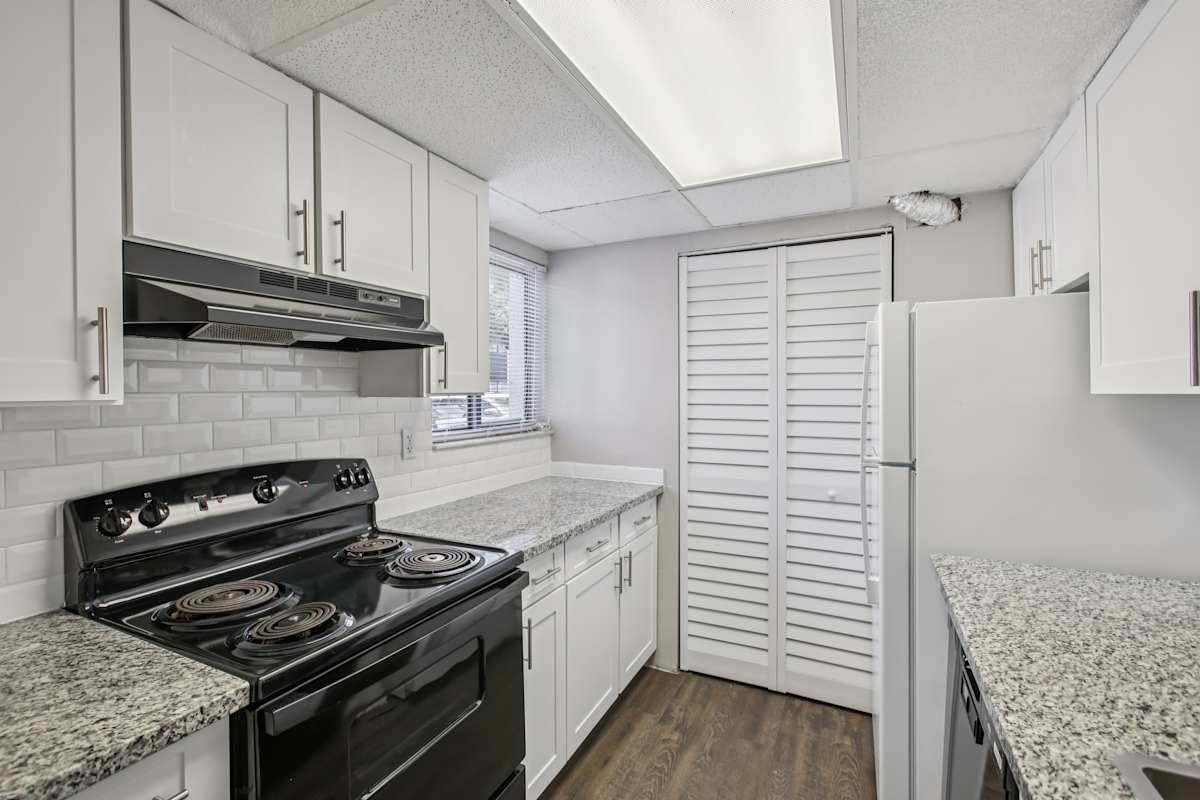 Meridian Luxury Condominiums kitchen with white cabinets - Tampa, FL