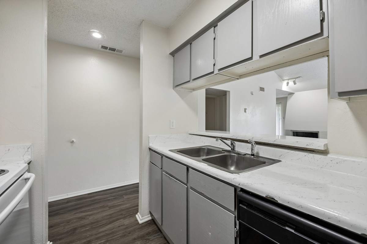 Tealwood Apartment Homes kitchen sink and stove - Dallas, TX