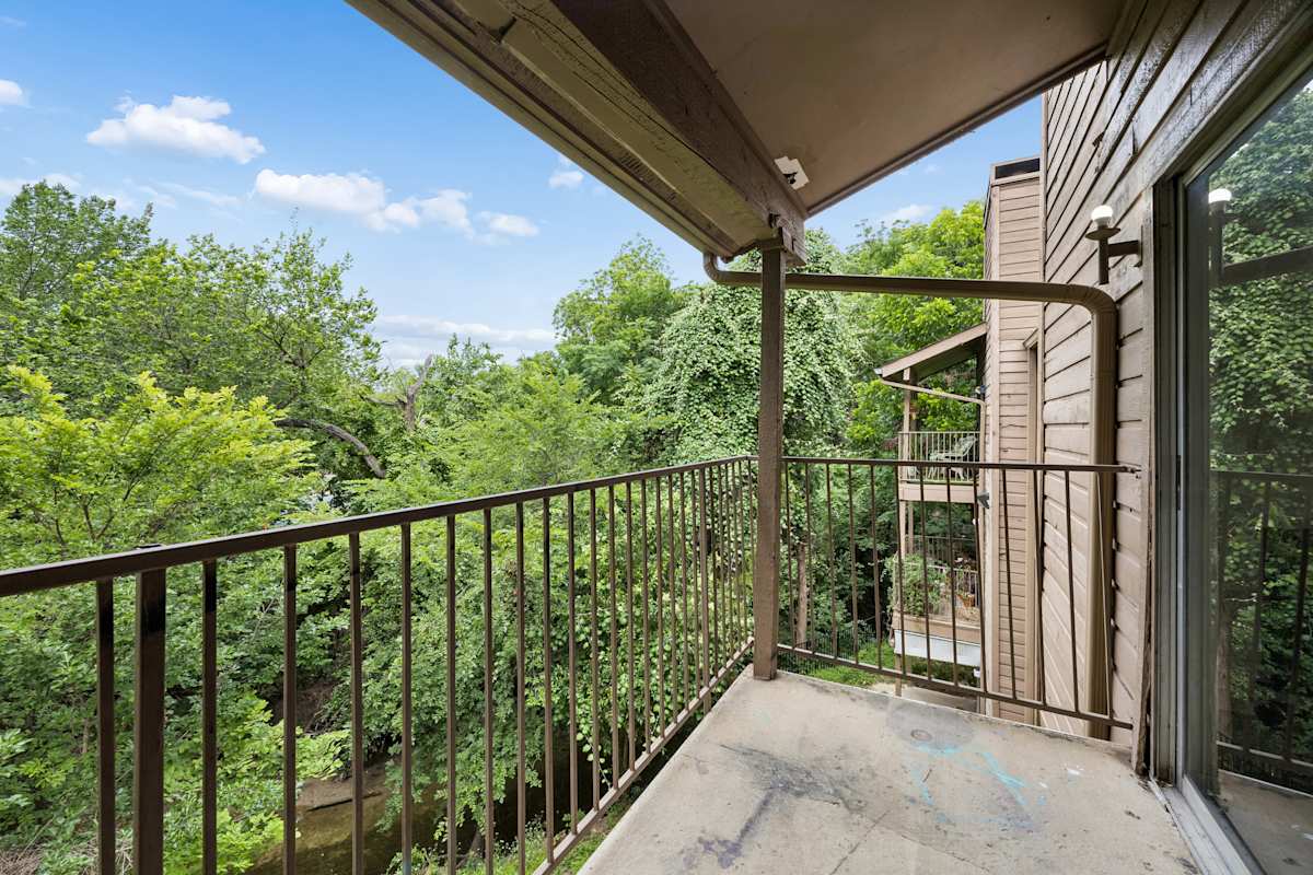 Tealwood Apartment Homes balcony overlooking trees - Dallas, TX