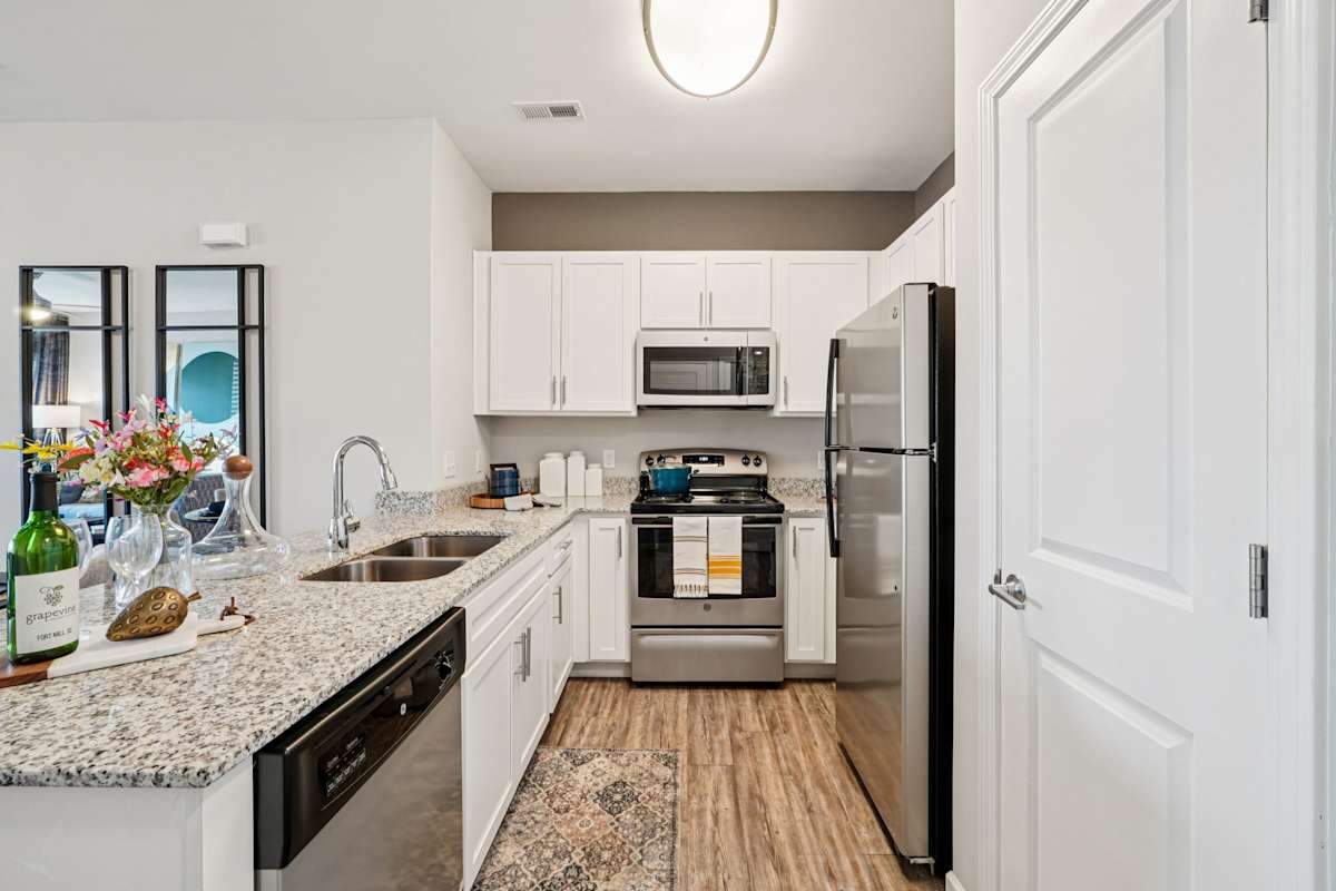 The Haven at Regent Park apartment kitchen with white cabinets - Fort Mill, SC
