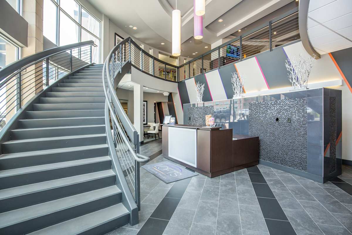 Lofts at Lincoln Station lobby with staircase and reception desk - Lone Tree, CO