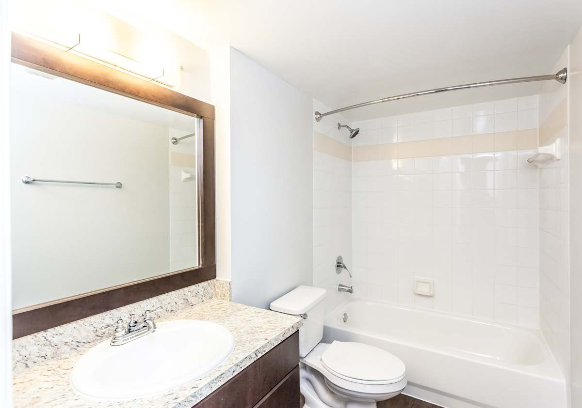 Sunset Gardens apartment bathroom with vanity and toilet - Miami, FL