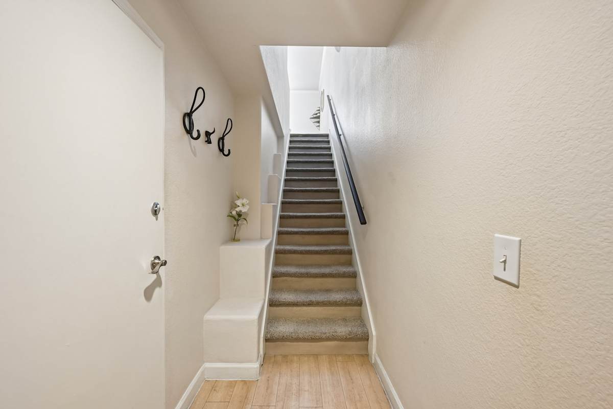 Interior staircase in the home shown — representative home at The Highland.