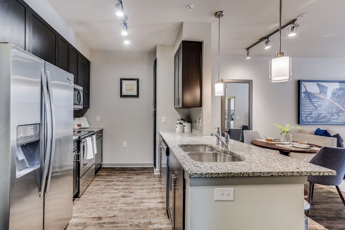 Junction 15 apartment kitchen with granite and stainless appliances - Plano, TX