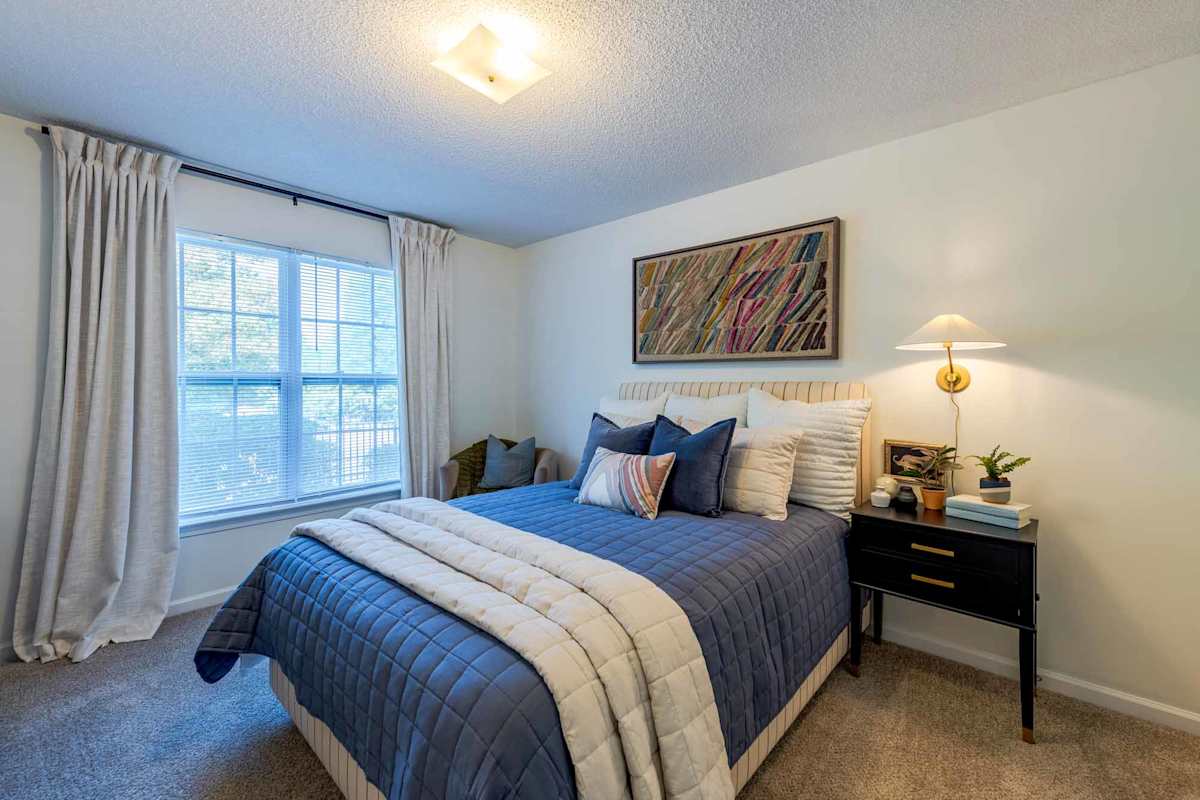 Berkshire Park bedroom with large bed and window - Knightdale, NC