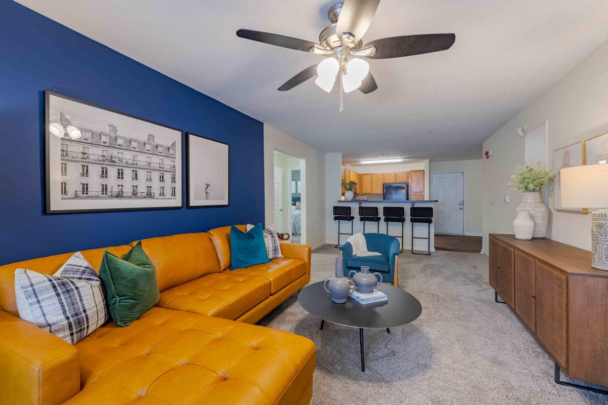 Reserve at Carrington Place apartment living room with yellow sofa - Fayetteville, NC