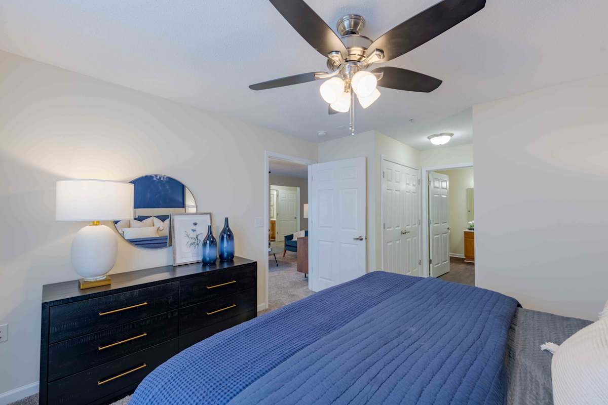 Reserve at Carrington Place apartment bedroom with blue bedding - Fayetteville, NC