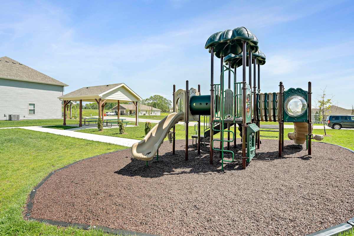Chapman Ridge Townhomes playground with slides - Blue Springs, MO