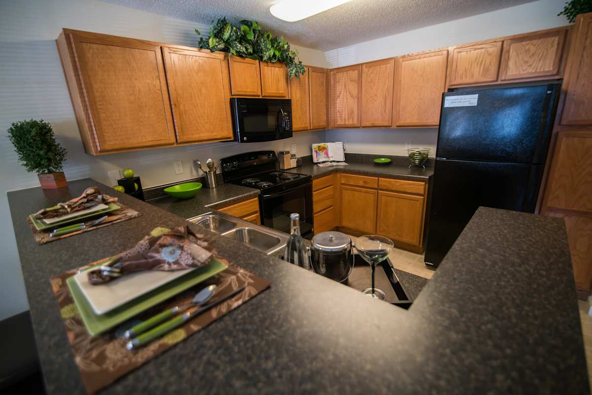 Legacy at Twin Oaks kitchen with black refrigerator - Greensboro, NC