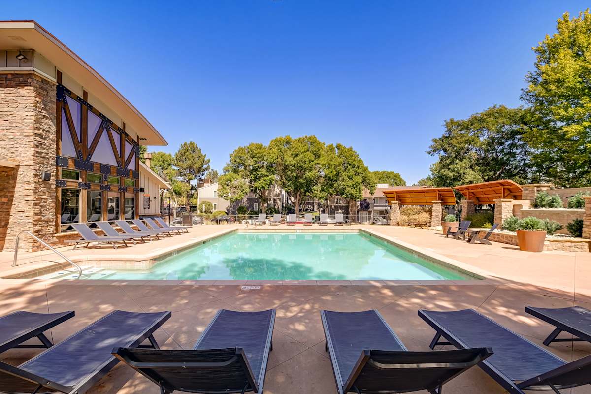 Copper Flats pool with loungers by the building - Aurora, CO