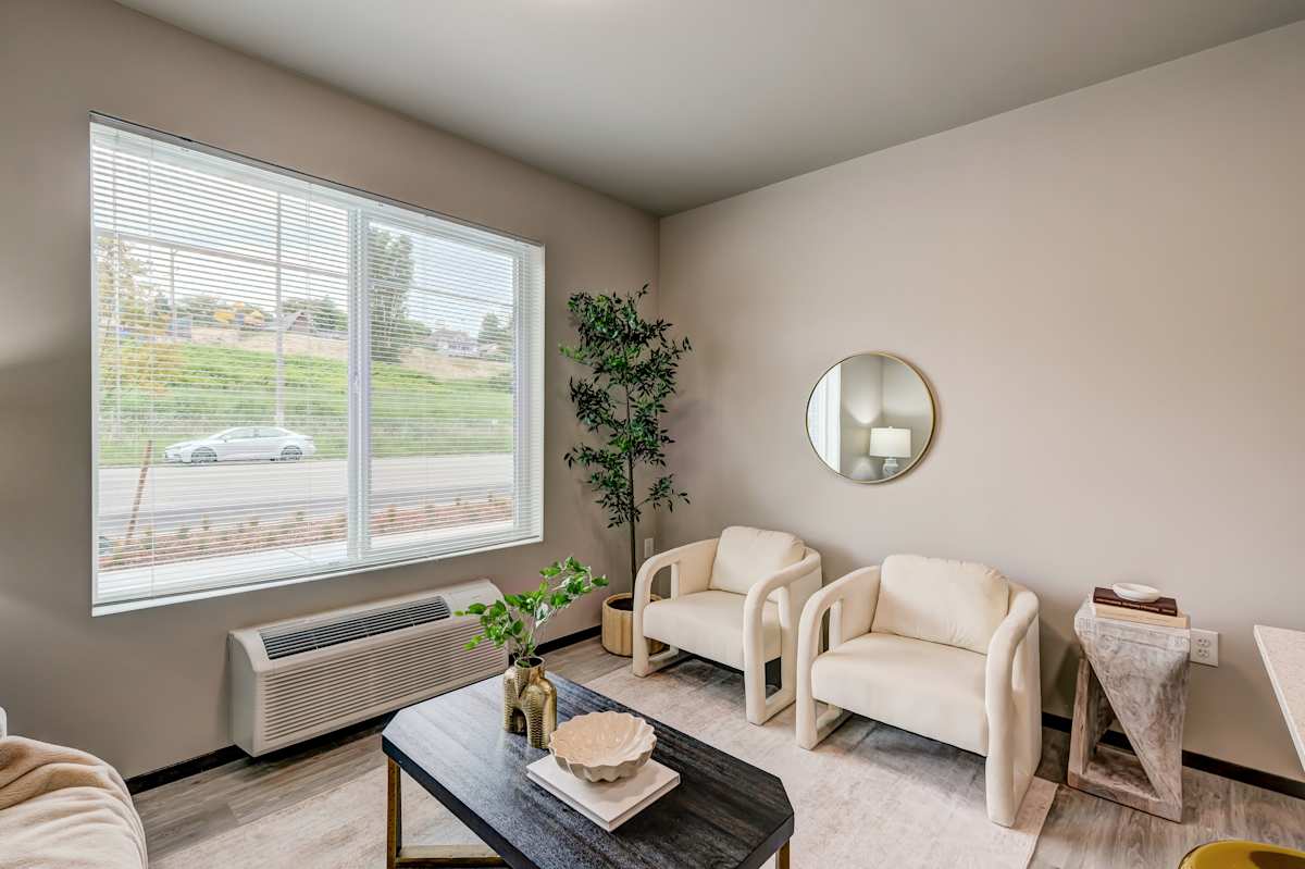 The Camden unit living room with large window - Tacoma, WA
