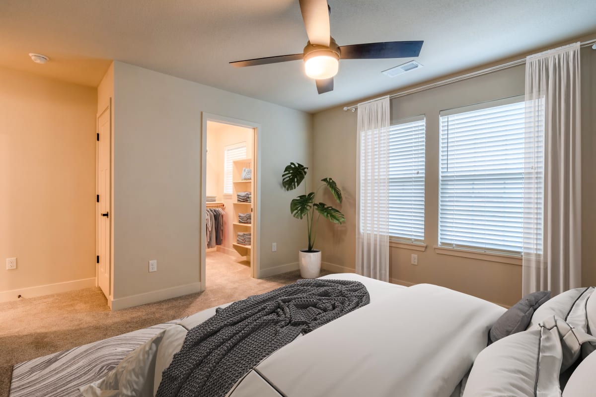The Venue Townhomes bedroom with ceiling fan - Raymore, MO