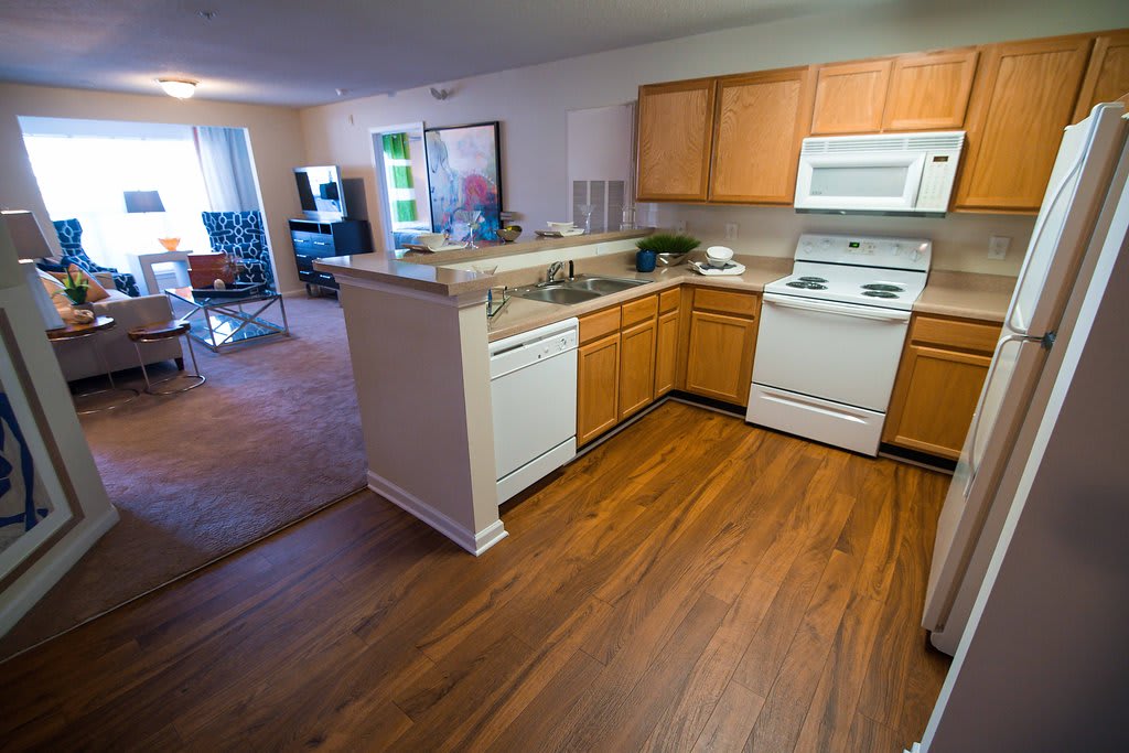Legacy at Friendly Manor kitchen with wood flooring and white appliances - Greensboro, NC