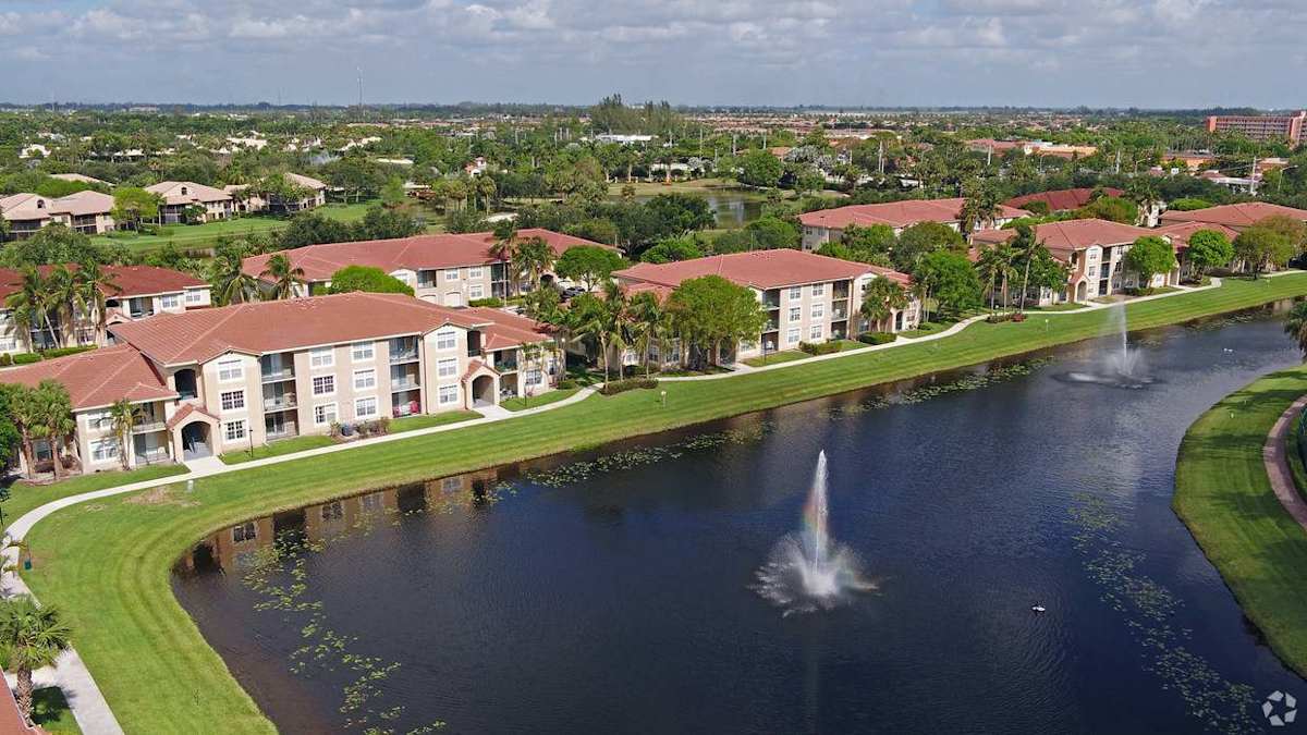 Murano at Delray Beach lake fountain in front of buildings - Delray Beach, FL