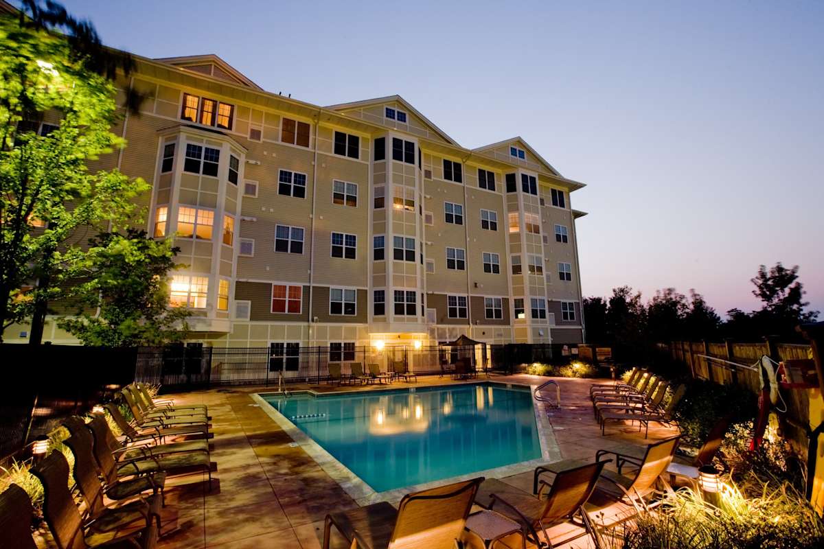 Canton Woods pool and building exterior at night - Canton, MA