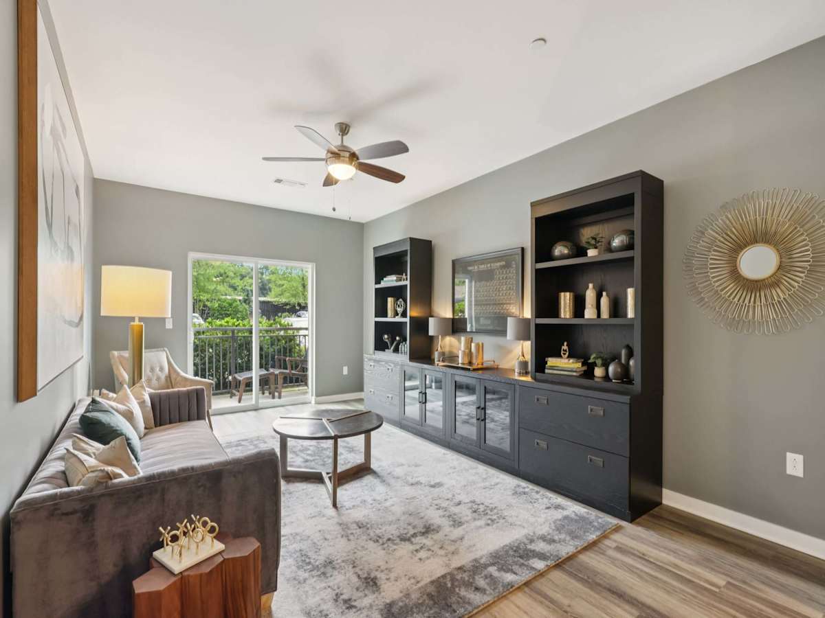 The Ashby at South Hills Village Station living room with patio door - Upper St Clair, PA