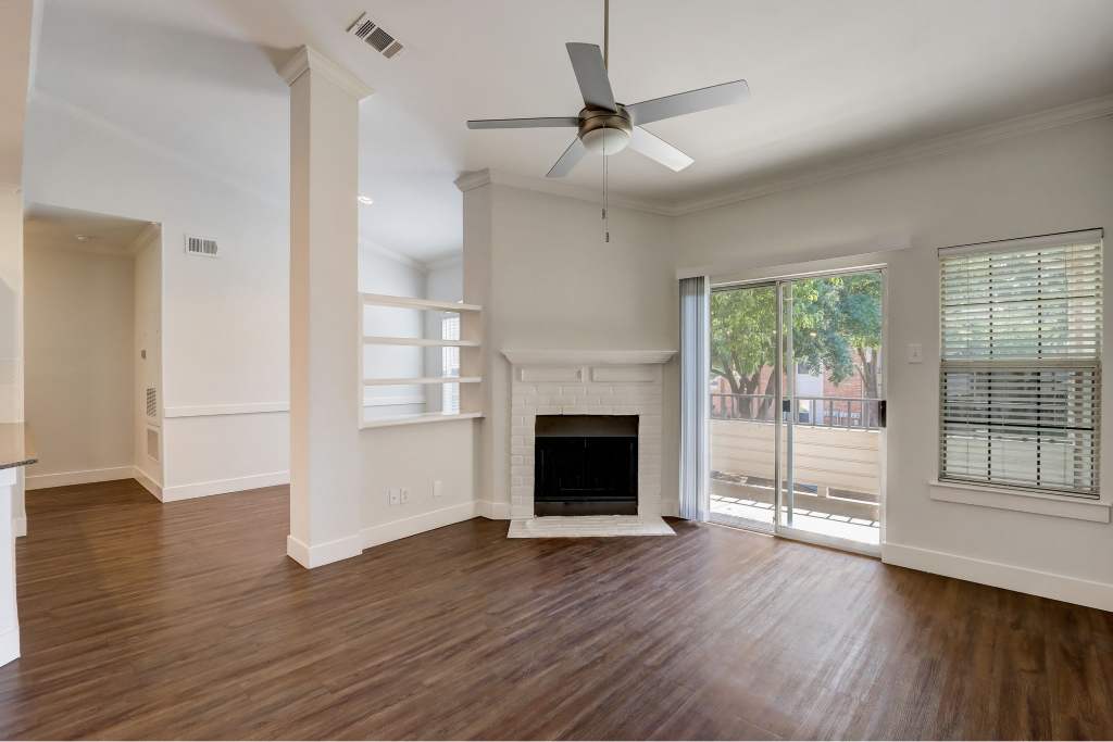 Courts of Bent Tree living room with fireplace and fan - Dallas, TX