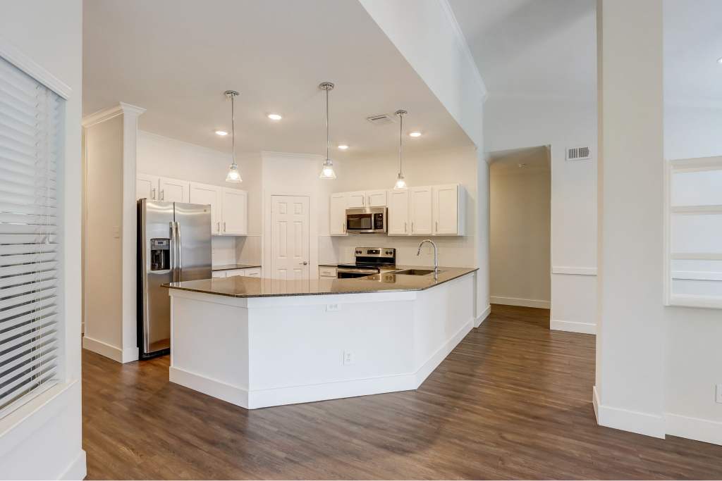 Courts of Bent Tree kitchen with island and white cabinets - Dallas, TX
