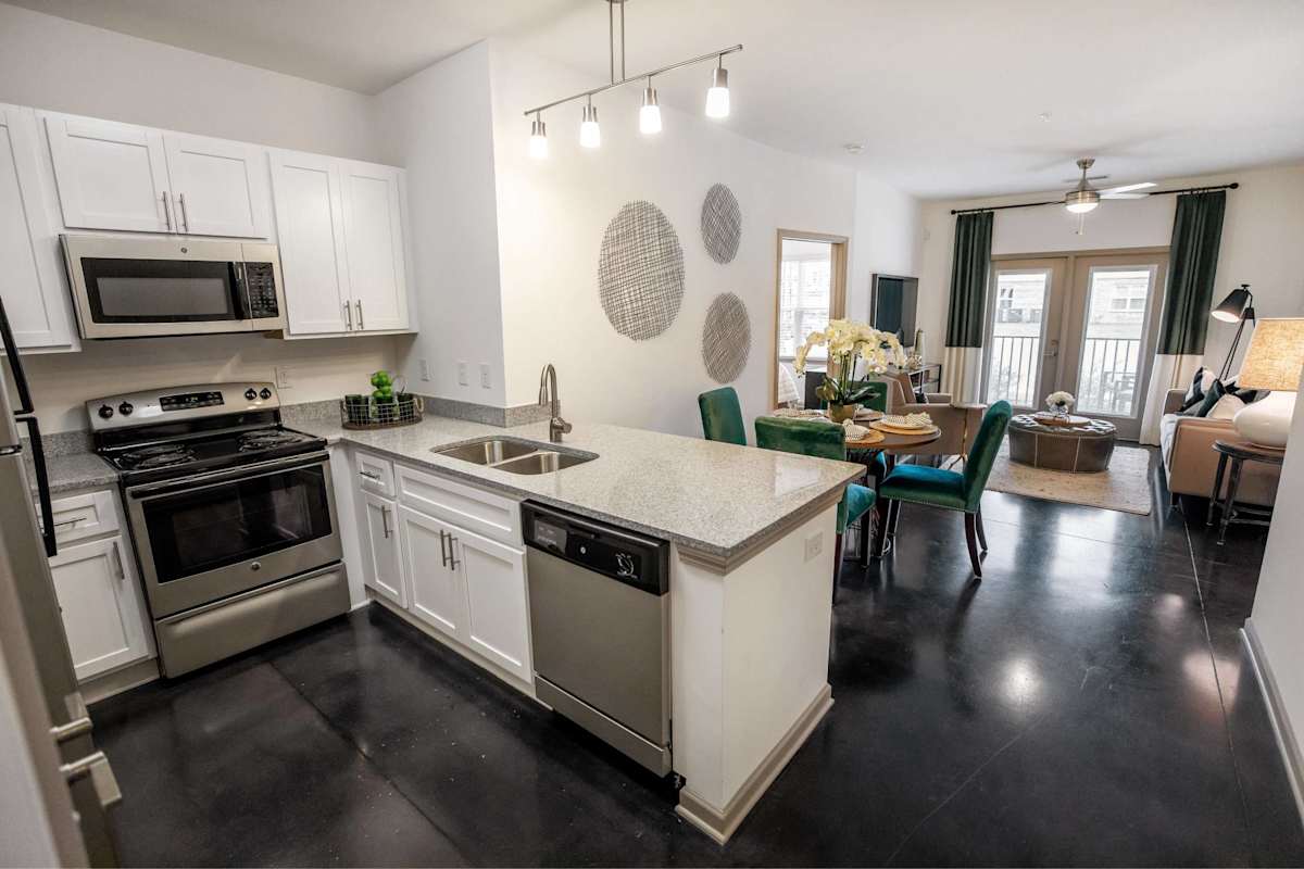 Country Park at Tall Oaks apartment kitchen with white cabinets - Greensboro, NC