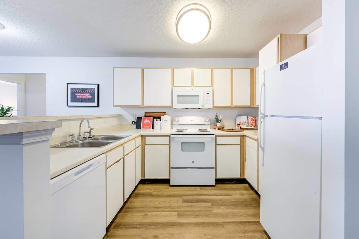 Legacy at Cross Creek kitchen with white cabinets and refrigerator - Fayetteville, NC